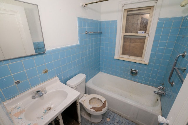 bathroom featuring toilet, a sink, tile walls, shower / washtub combination, and tile patterned floors