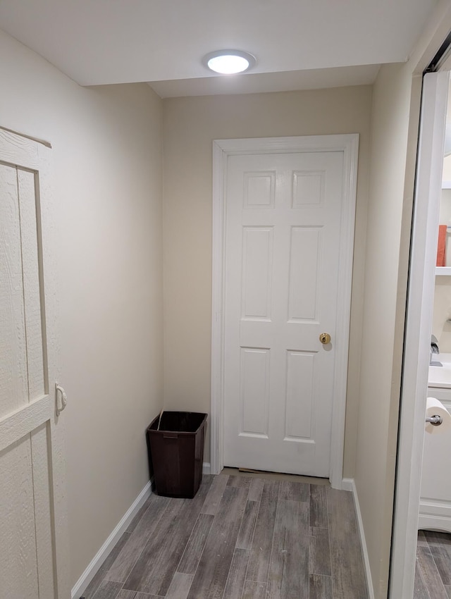 doorway to outside with wood finished floors and baseboards