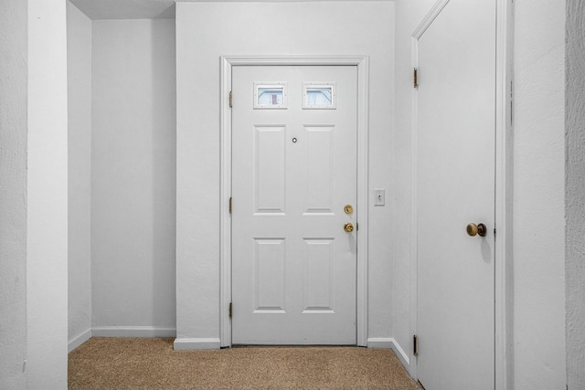 entryway featuring carpet and baseboards