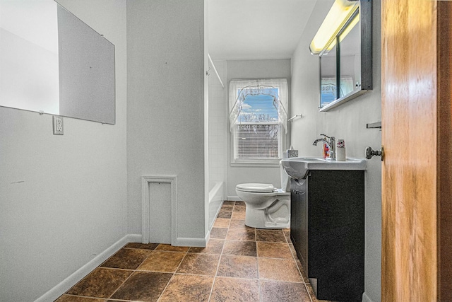 full bath featuring stone tile floors, baseboards, toilet, vanity, and shower / bathtub combination