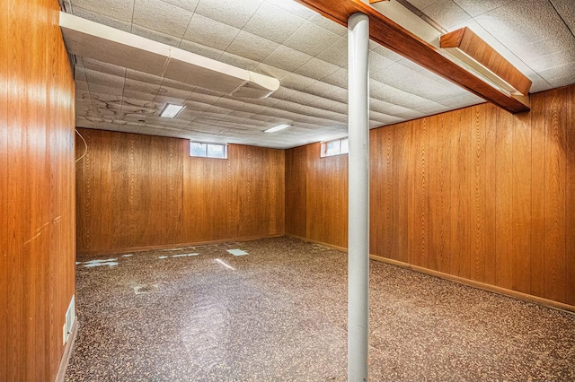 basement with wooden walls and baseboards