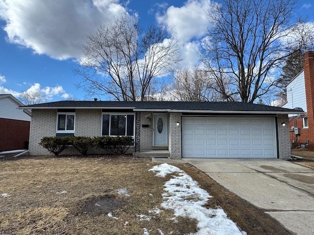 single story home featuring concrete driveway, brick siding, and an attached garage