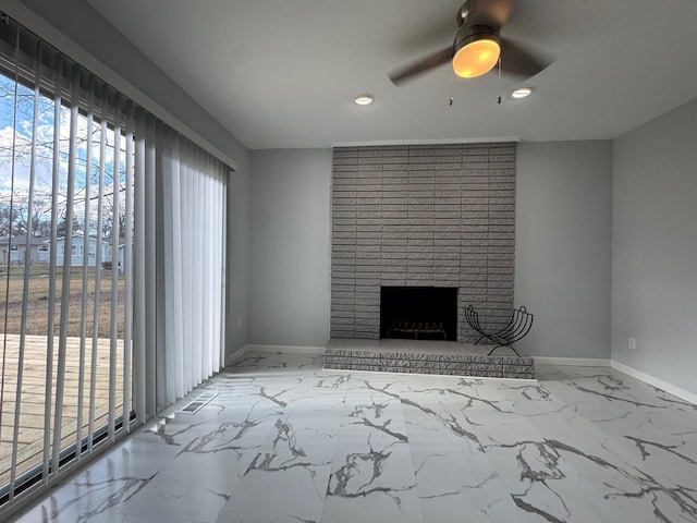 unfurnished living room with recessed lighting, a ceiling fan, baseboards, marble finish floor, and a brick fireplace