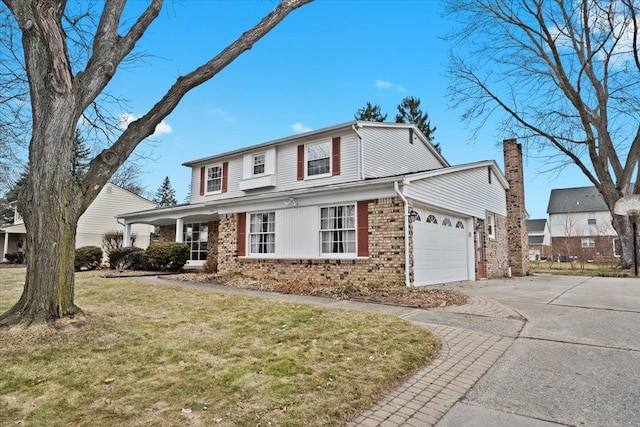 traditional home with a front lawn, concrete driveway, brick siding, and an attached garage