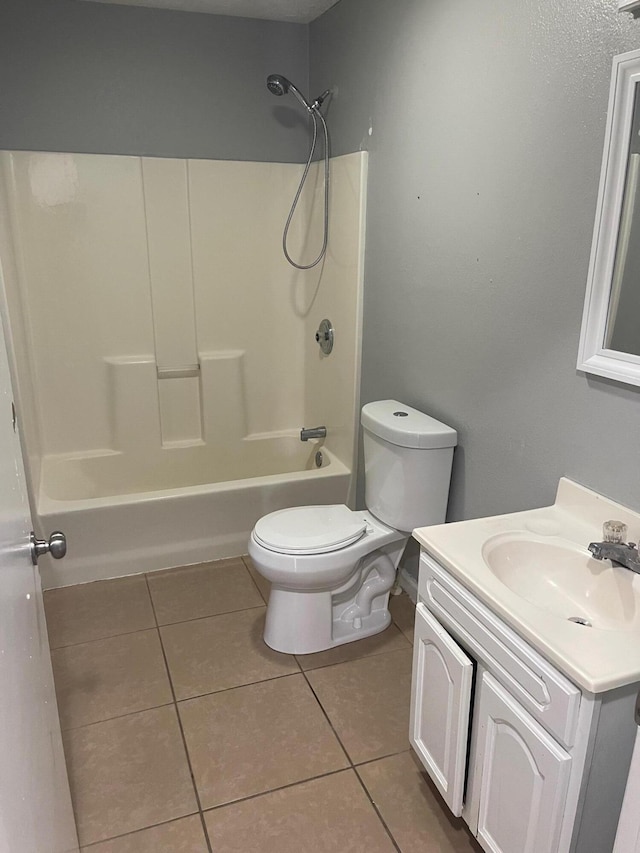 bathroom featuring toilet, bathing tub / shower combination, vanity, and tile patterned floors