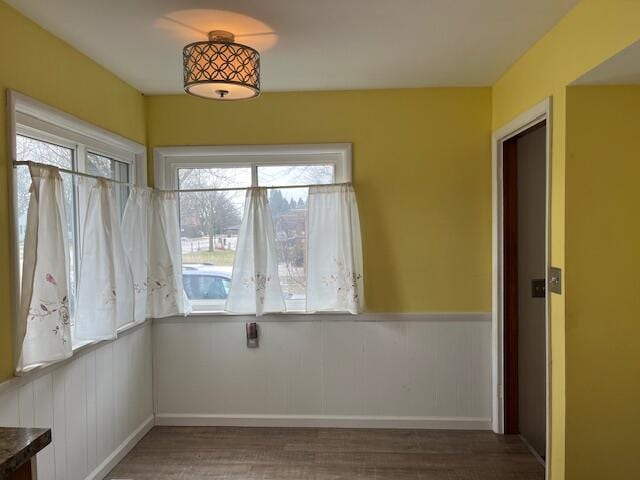 empty room featuring a wainscoted wall and wood finished floors