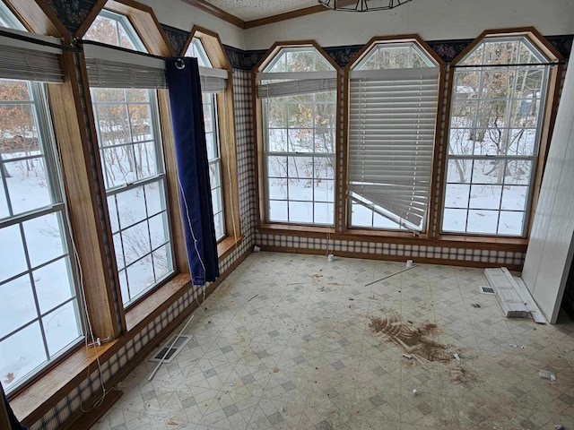 spare room featuring visible vents, crown molding, and tile patterned floors