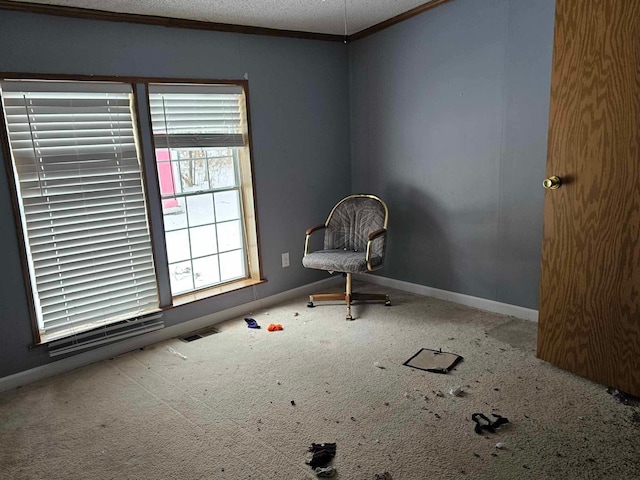 carpeted spare room featuring baseboards, visible vents, a textured ceiling, and ornamental molding