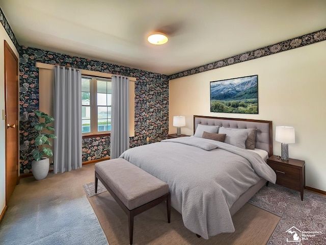 bedroom featuring wallpapered walls, carpet flooring, and baseboards