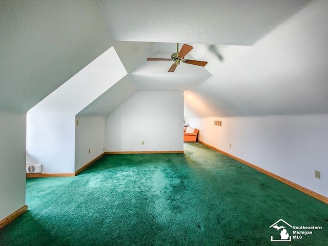 bonus room featuring carpet floors, vaulted ceiling, baseboards, and ceiling fan