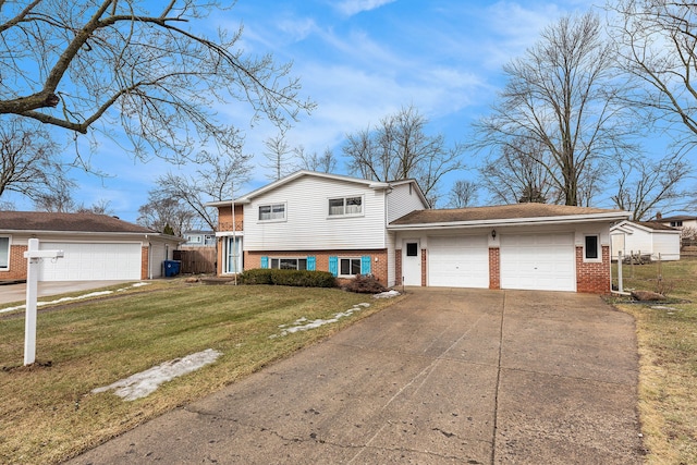 tri-level home featuring concrete driveway, brick siding, an attached garage, and a front yard