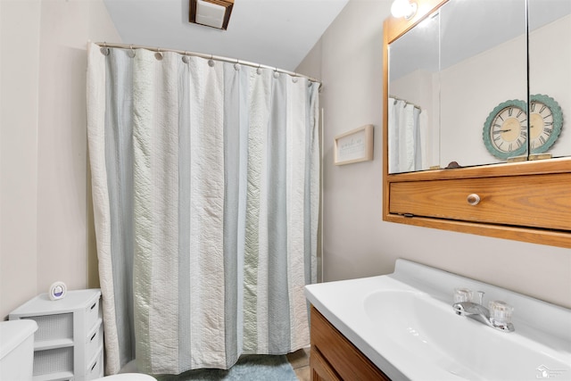 bathroom featuring vanity and toilet