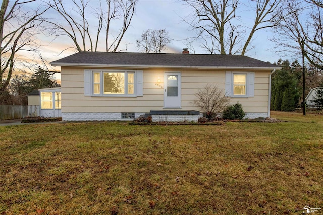 view of front of home featuring a chimney and a lawn