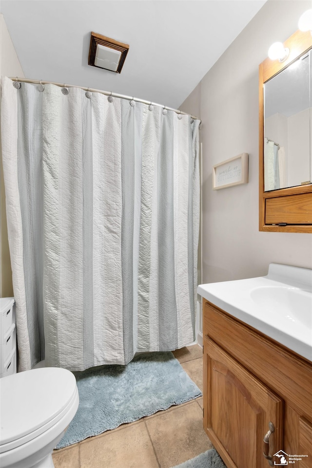 bathroom featuring vanity, toilet, and tile patterned floors