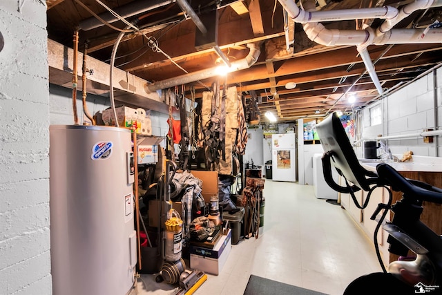 basement with electric water heater, water heater, and freestanding refrigerator