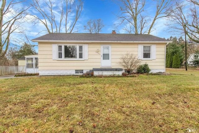 view of front of home with a chimney, fence, and a front lawn