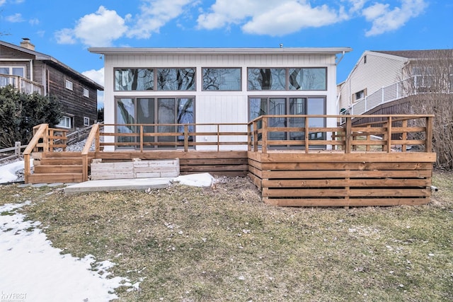 rear view of house featuring a wooden deck