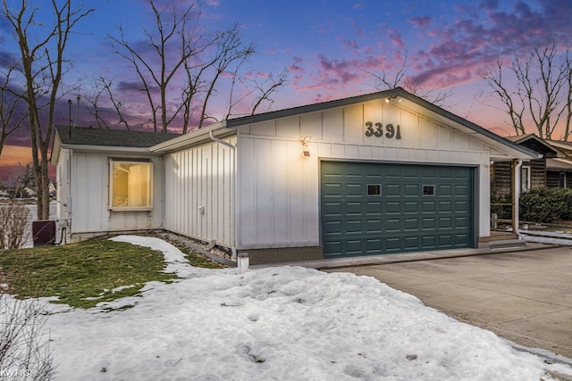 exterior space featuring concrete driveway and an attached garage