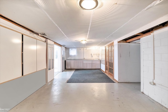 basement featuring concrete block wall and visible vents