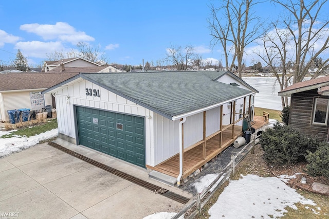 view of front of property with a garage, a shingled roof, and board and batten siding