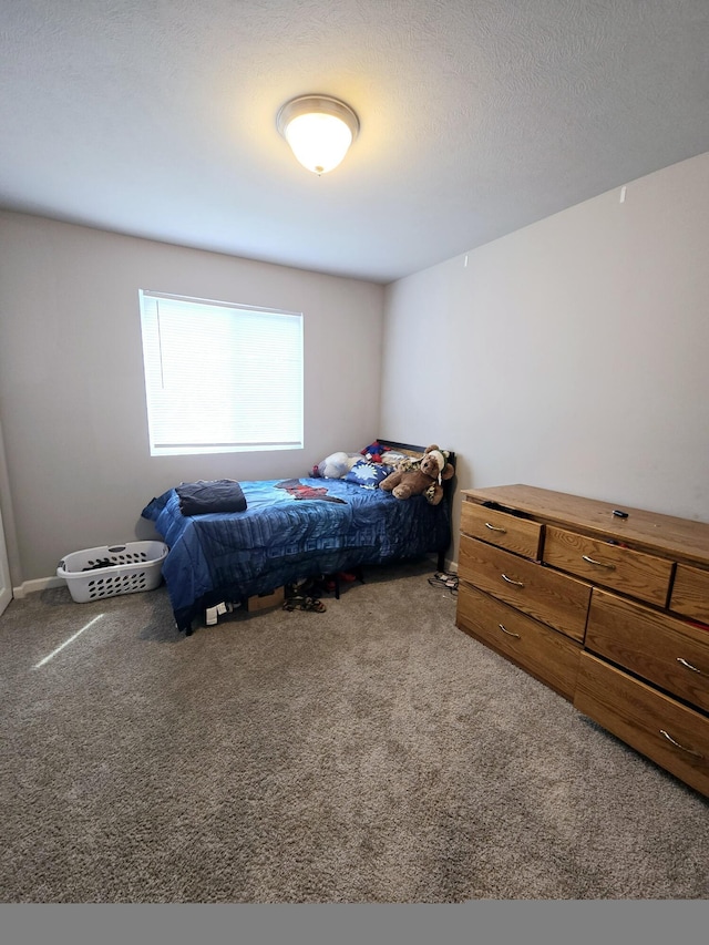 bedroom featuring carpet floors and a textured ceiling