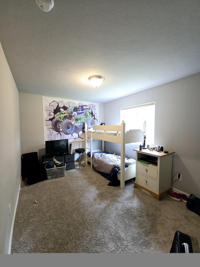 bedroom with carpet, a textured ceiling, and baseboards