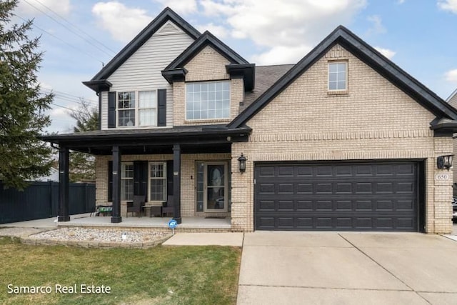 craftsman-style house with covered porch, brick siding, fence, and concrete driveway