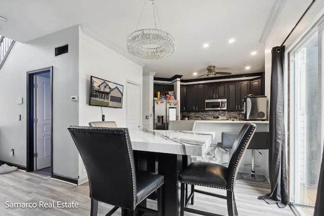 dining area featuring light wood finished floors, visible vents, ceiling fan, ornamental molding, and recessed lighting