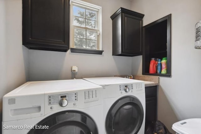 clothes washing area with cabinet space and washing machine and clothes dryer