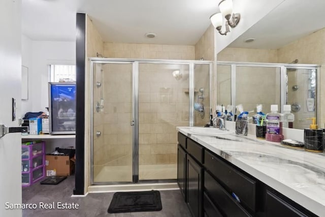 bathroom with a stall shower and vanity