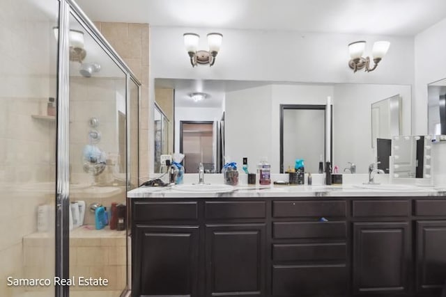 full bath with double vanity, a sink, and a shower stall