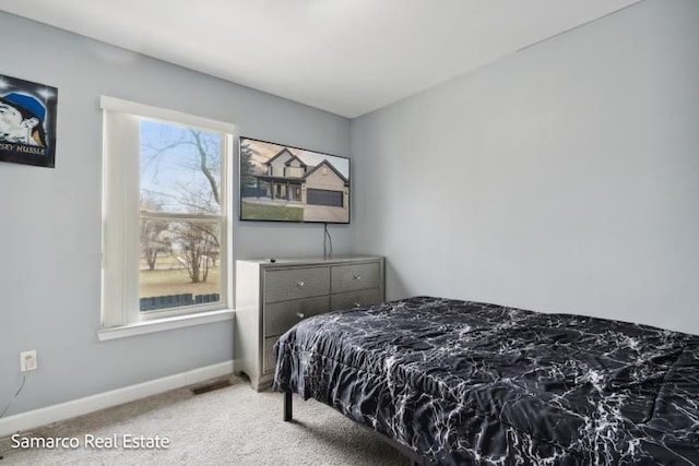 carpeted bedroom with visible vents and baseboards