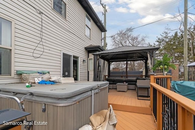 wooden deck featuring a hot tub, an outdoor living space, and a gazebo