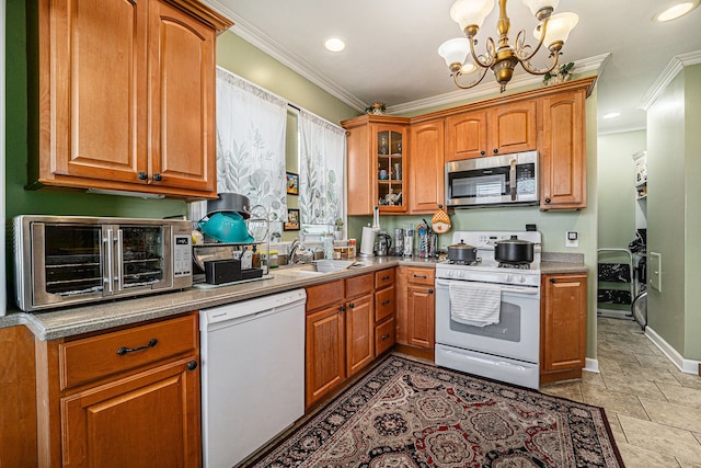 kitchen featuring ornamental molding, white appliances, glass insert cabinets, and a sink