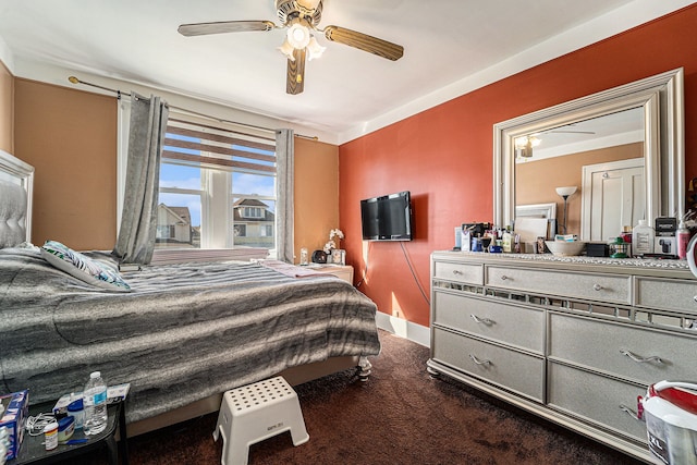 bedroom featuring baseboards, dark carpet, and a ceiling fan