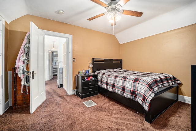 carpeted bedroom featuring lofted ceiling, ceiling fan, visible vents, and baseboards