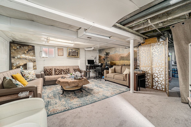 carpeted living room featuring concrete block wall