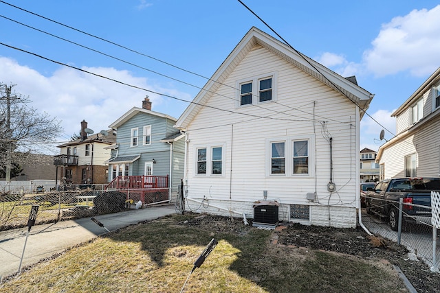 back of property with fence private yard and central AC unit