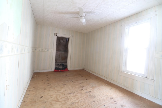 unfurnished room featuring a ceiling fan