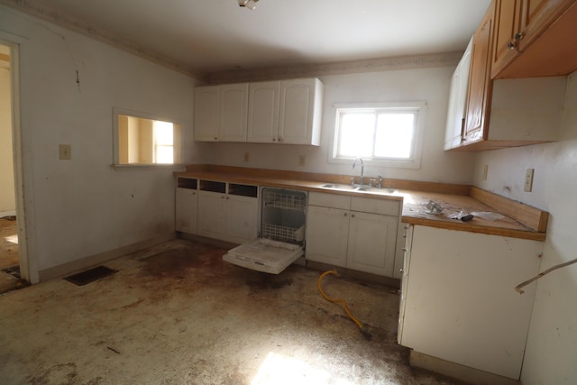 kitchen featuring visible vents, white cabinets, dishwasher, light countertops, and a sink