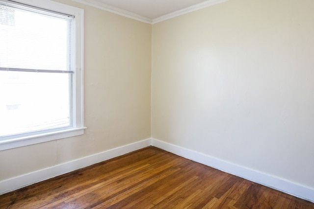 unfurnished room featuring ornamental molding, dark wood-style flooring, and baseboards