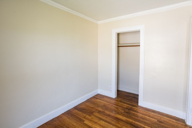 unfurnished bedroom featuring crown molding, a closet, baseboards, and dark wood-type flooring