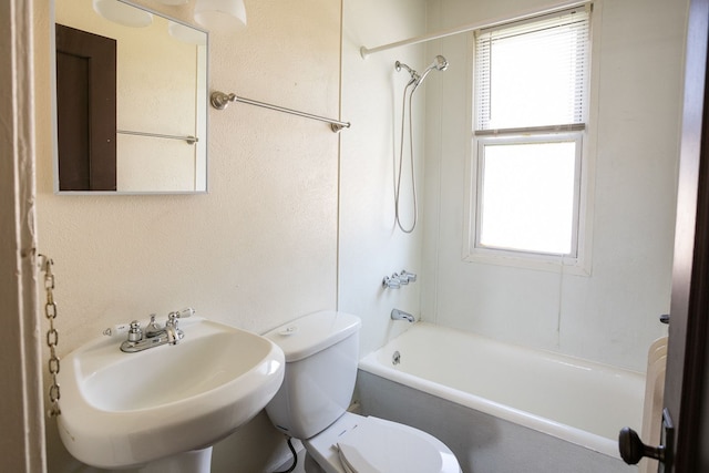 bathroom with shower / tub combination, a sink, and toilet