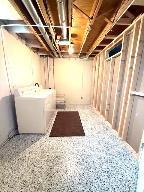 unfinished basement with independent washer and dryer