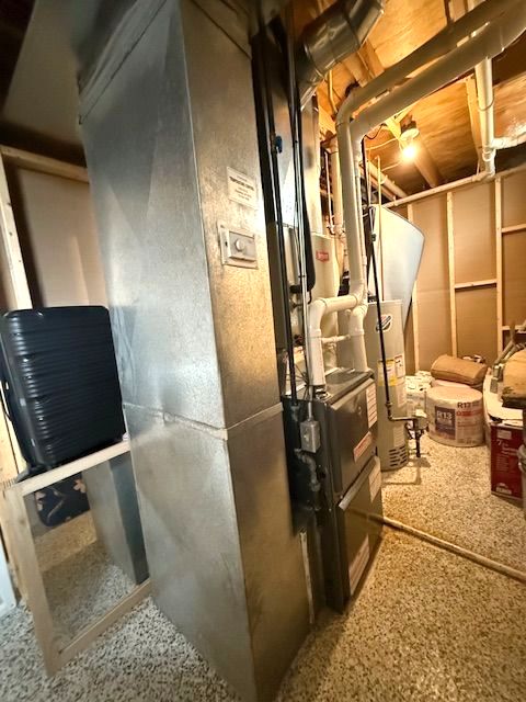 utility room with gas water heater