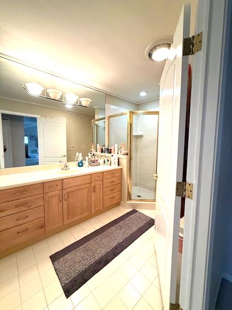 full bath featuring tile patterned floors, a shower stall, and vanity