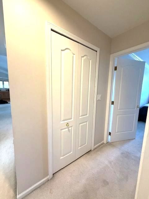 corridor with carpet and baseboards