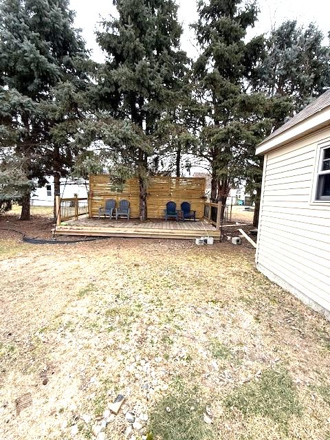 view of yard with fence and a wooden deck