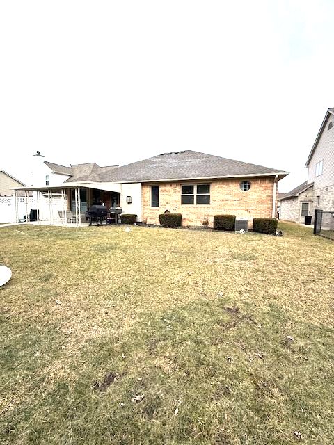 back of house with a lawn