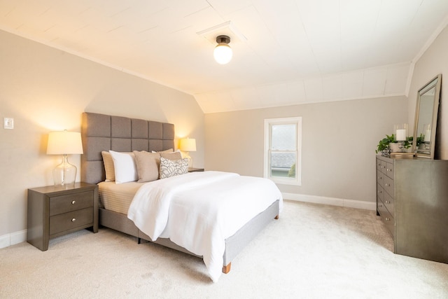 bedroom with light carpet, lofted ceiling, and baseboards